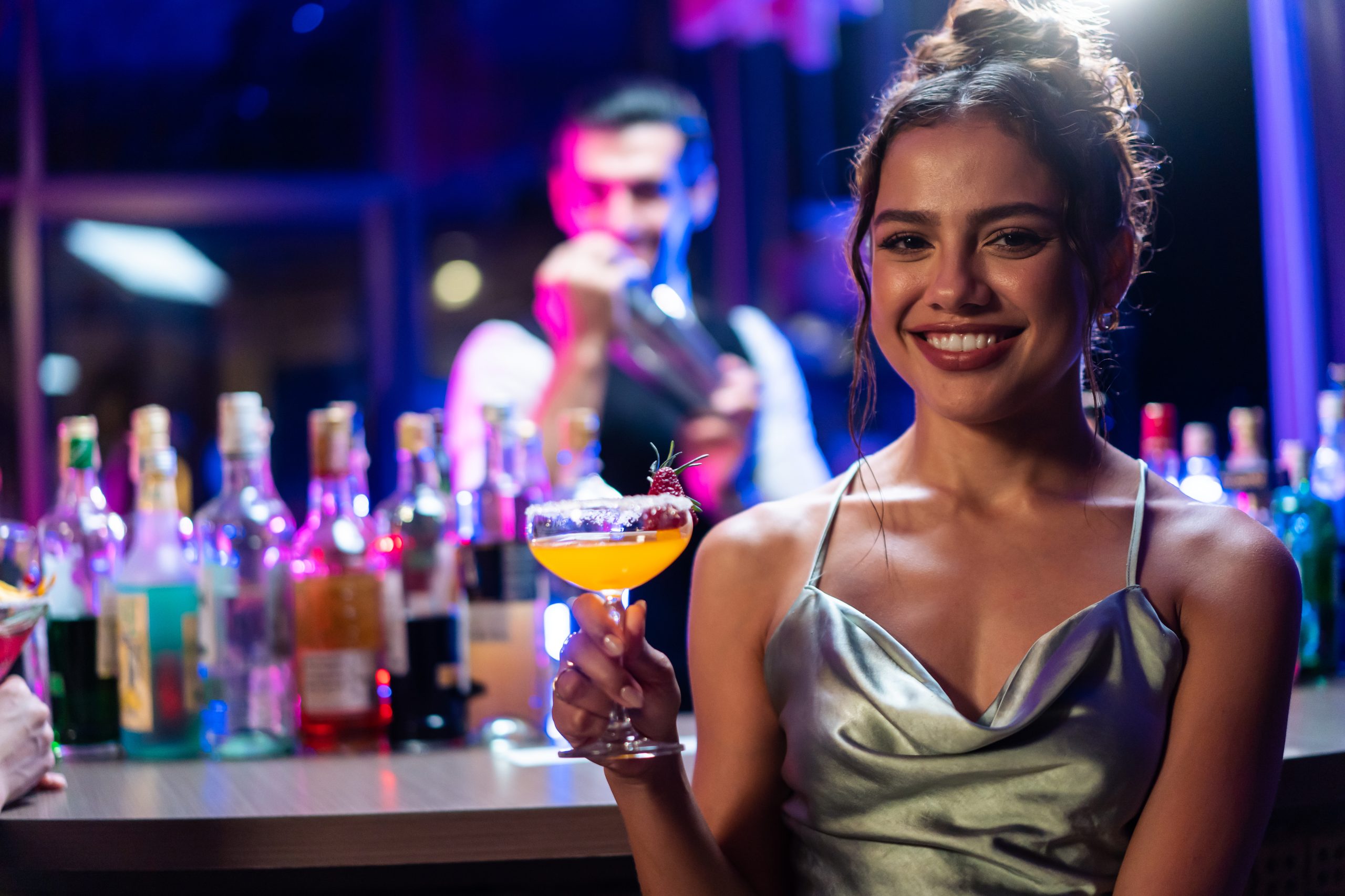 Beautiful woman having fun in billiards bar restaurant lounge. Attractive young girl drinking alcohol to celebrating event at night club.