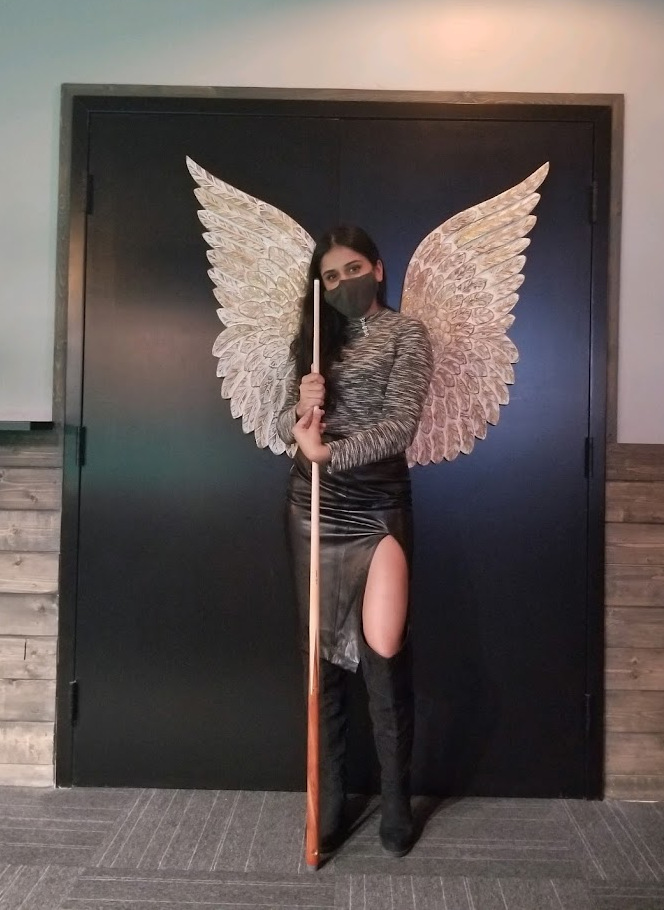 Woman playing pool in pool room that uses CuetPOS Billiards POS software.