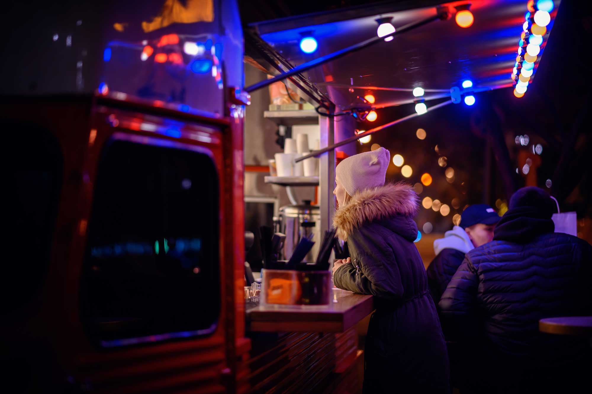 young-woman-making-order-at-street-food-truck-2023-11-27-04-56-09-utc